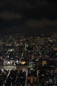 High angle view of illuminated cityscape against sky at night