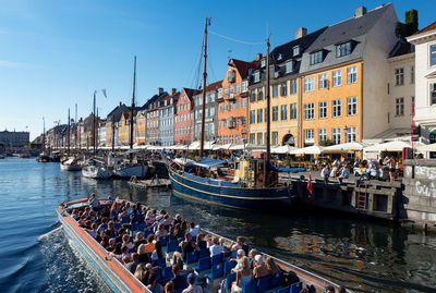 Tourist making a baot trip at the famous district of nyhavn in copenhagen denmark