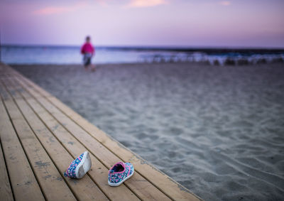 Baby booties on beach