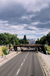 Bridge over road against sky in city