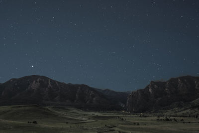 Scenic view of mountains against sky at night