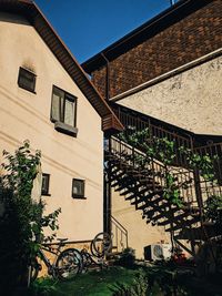 House and building against clear sky