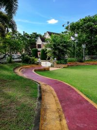 View of footpath by building against sky