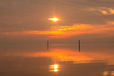 Scenic view of sea against romantic sky at sunset