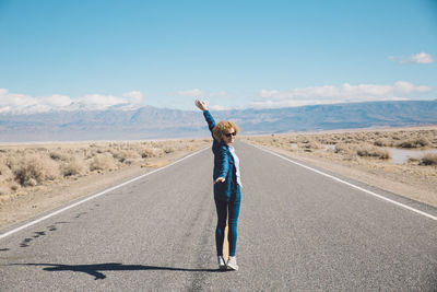 Full length of woman on road against sky