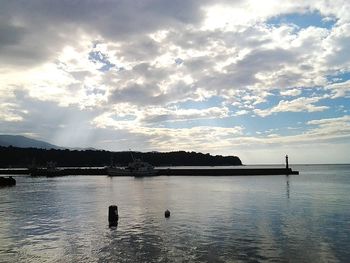 View of calm sea against cloudy sky