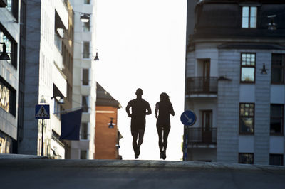 Couple running on road, stockholm, sweden