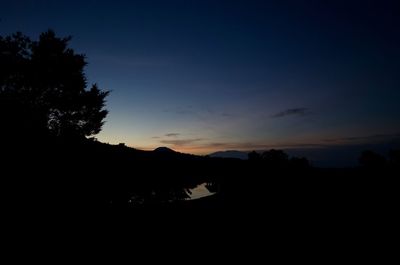 Silhouette trees against sky during sunset