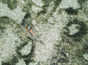 Aerial view of woman kayaking in sea