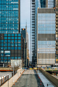 Street amidst modern buildings in city