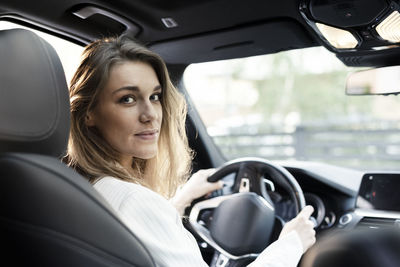 Portrait of woman sitting in car