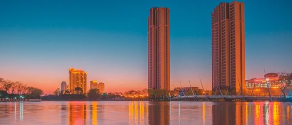 City at waterfront during sunset