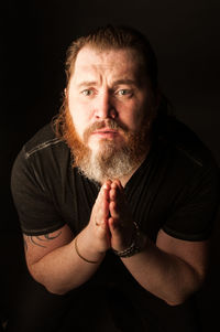 Portrait of man against black background