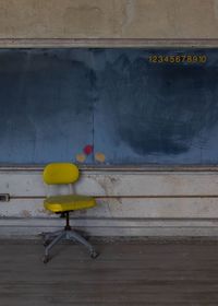 Close-up of yellow toy against wall