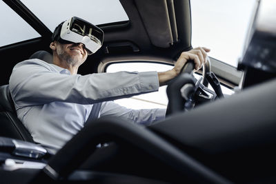 Businessman wearing vr glasses driving a car