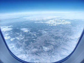 Aerial view of clouds seen from airplane window