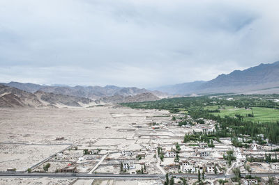 Scenic view of mountains against cloudy sky