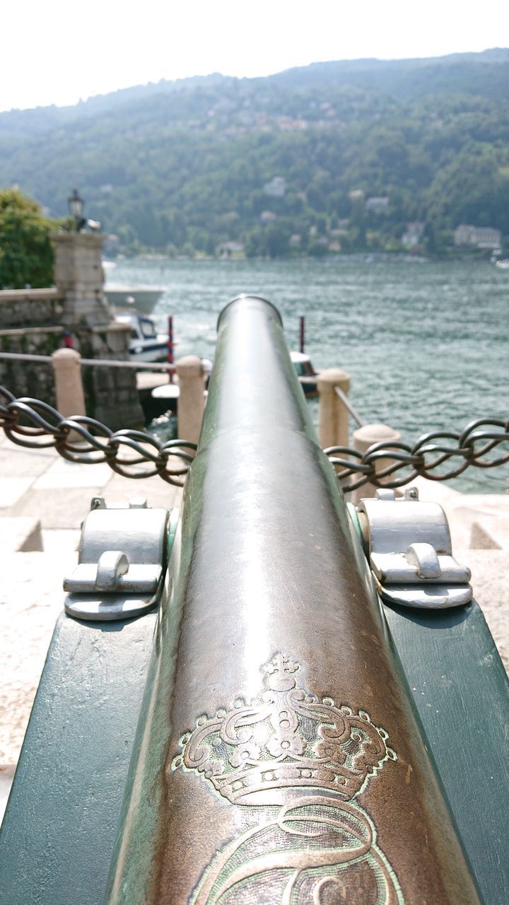 CLOSE-UP OF RAILING AGAINST SEA