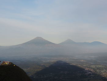 Scenic view of mountains against cloudy sky