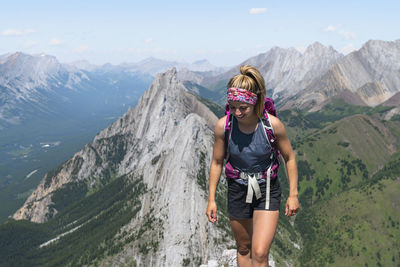 Female hiking along rocky ridge in alberta's kananaskis country