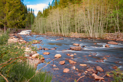 River landscape in the swedish vaermland with a stony river bed, taken with a long exposure