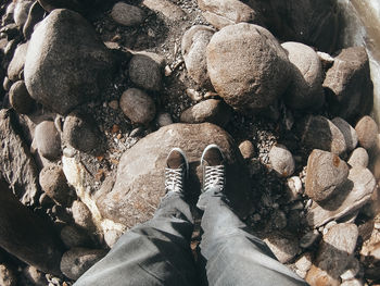 Low section of person standing on rocks