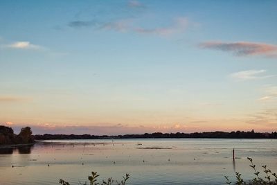 Scenic view of calm lake at sunset