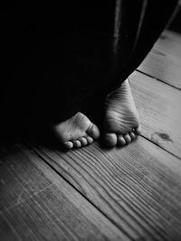 Low section of child on wooden floor