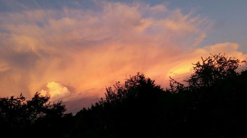 Silhouette of landscape against cloudy sky