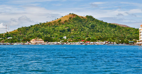 Scenic view of sea and buildings against sky