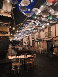 Chairs and tables in restaurant at night