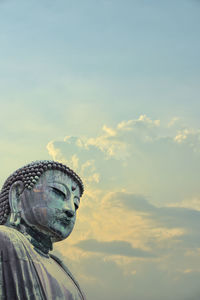 Low angle view of statue against sky