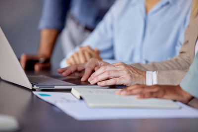 Midsection of man using laptop