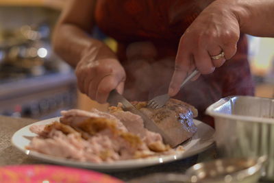Cropped image of woman eating food