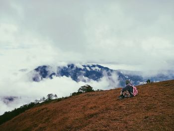 Man on mountain against sky