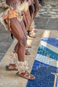 Low section of woman walking on floor