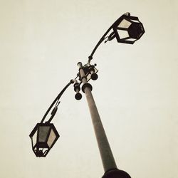 Low angle view of electric lamp against clear sky