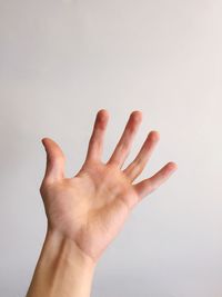 Close-up of human hand against white background