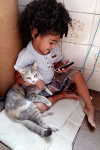 Midsection of a girl holding cat