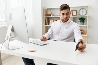 Portrait of young man working on table