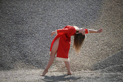 Full length of woman standing on road