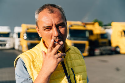 Portrait of young man smoking cigarette