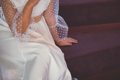 Midsection of bride sitting
