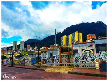 Buildings against cloudy sky