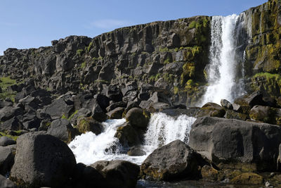 A large waterfall over a rocky cliff - Öxaráfoss in thingvellir national park.