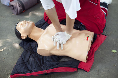 Low section of woman applying cpr on dummy