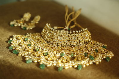 High angle view of necklace on wooden table