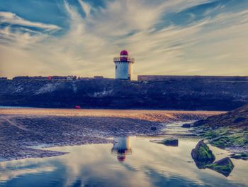 Burry port lighthouse at harbor against sky