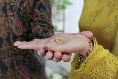 Close-up of couple holding hands