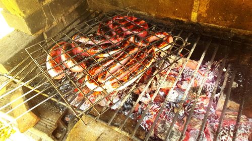 High angle view of meat on barbecue grill